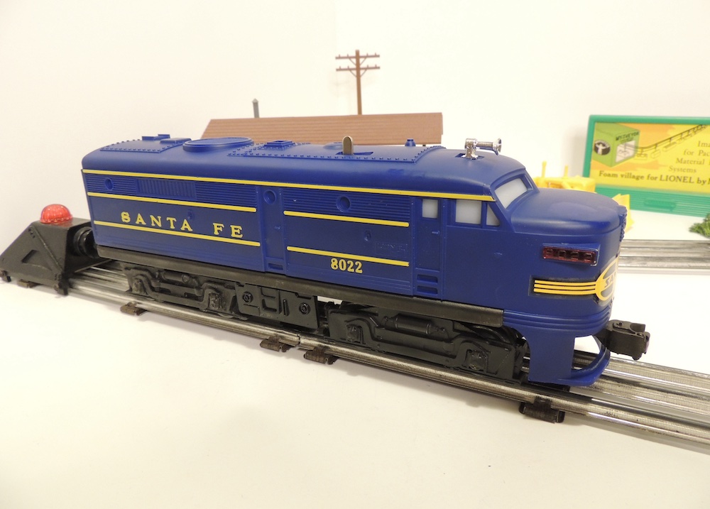 blue model locomotive on track