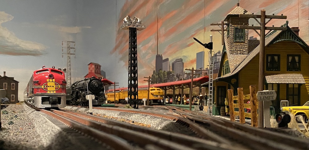 three locomotives on toy train layout