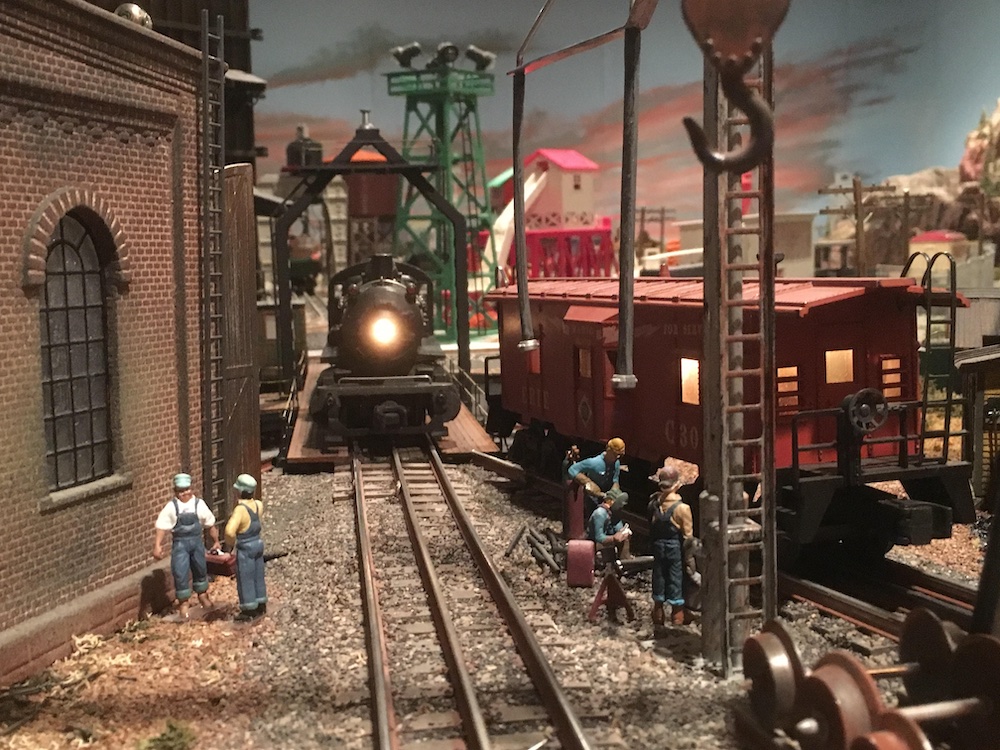  steam locomotive with headlight on coming toward you on layout