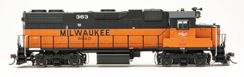Color photo of HO scale diesel painted orange and black on white background