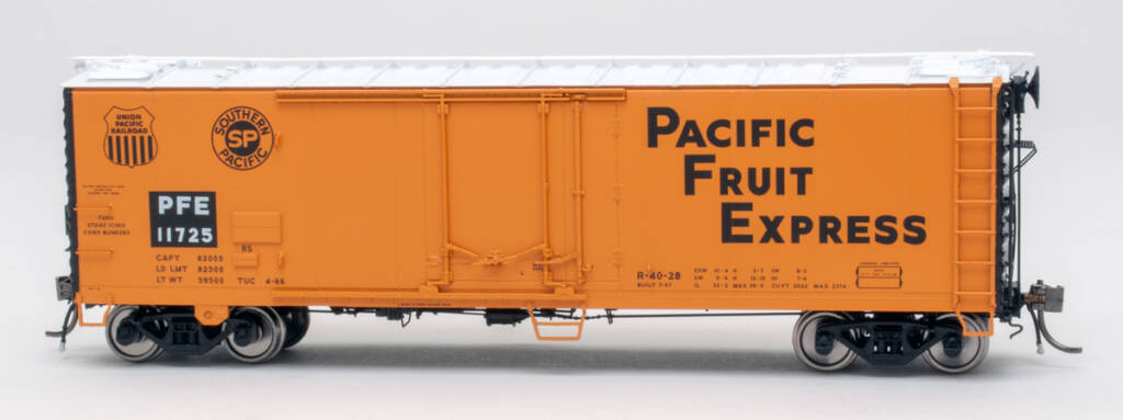Color photo of HO scale refrigerator car painted orange and black on white background.
