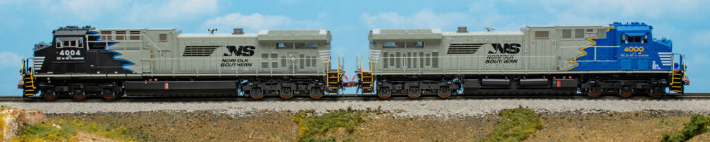 Color photo of two HO scale diesels on scenicked base