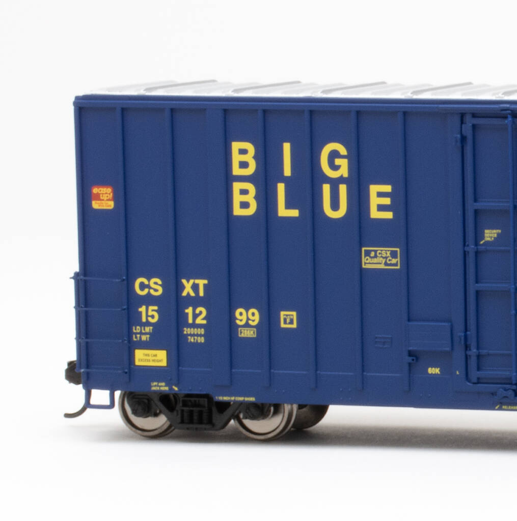 Color photo HO scale boxcar painted dark blue with silver roof and yellow graphics.