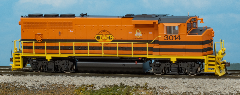 Color photo of HO scale diesel locomotive painted orange, black, and yellow on scenicked base