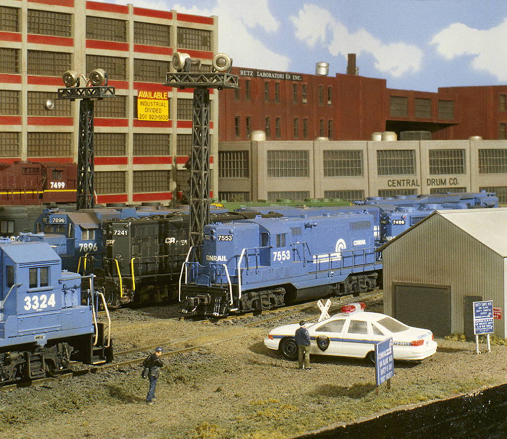 Two blue conrail locomotives on a model railroad layout