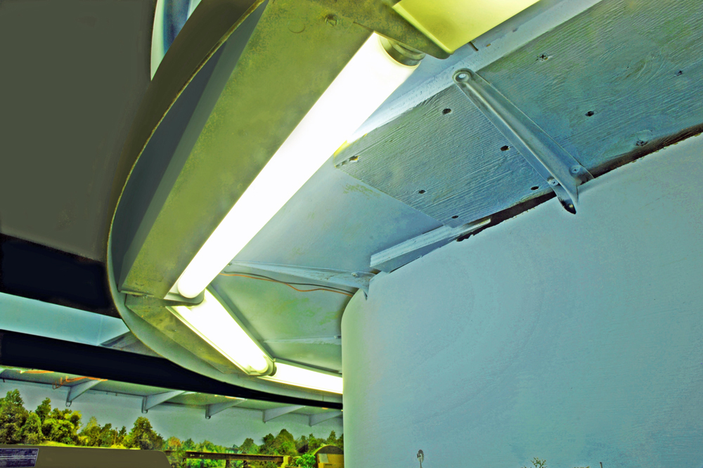 Color photo showing bottom of upper deck on HO scale layout