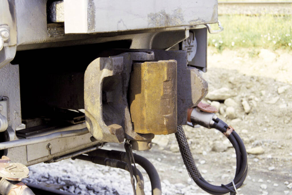 Color photo of rusty coupler on passenger car