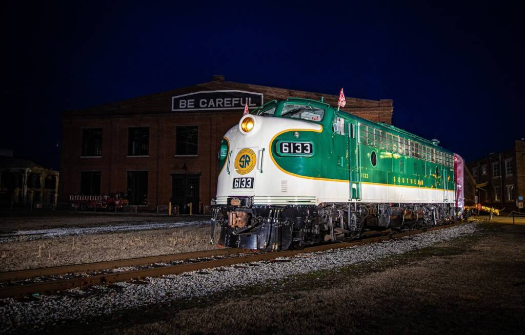 Green streamlined diesel locomotive at night