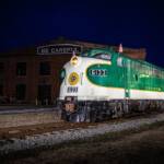 Green streamlined diesel locomotive at night