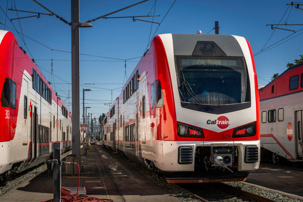 Red and white electric mutliple-unit commuter trains at station