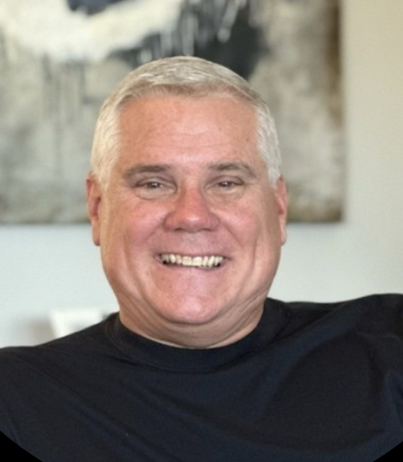 Head shot of smiling man in black shirt