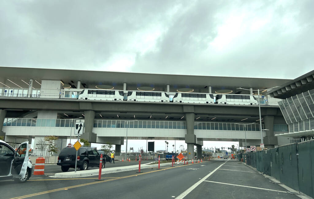 People mover cars at station over street