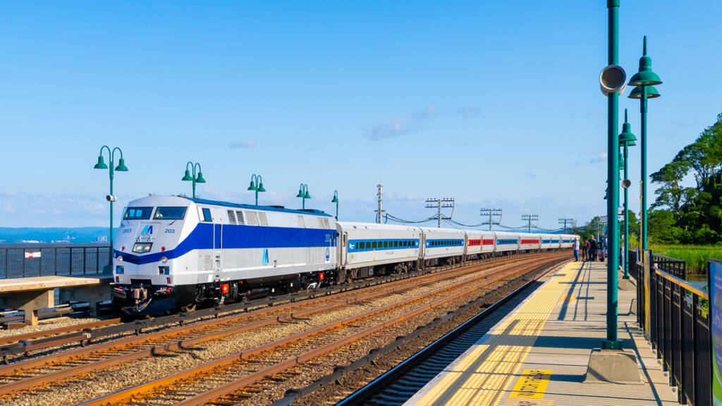 Silver and blue locomotive on commuter train