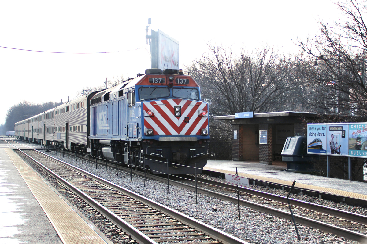 Commuter train at station with platform and open-air shelter
