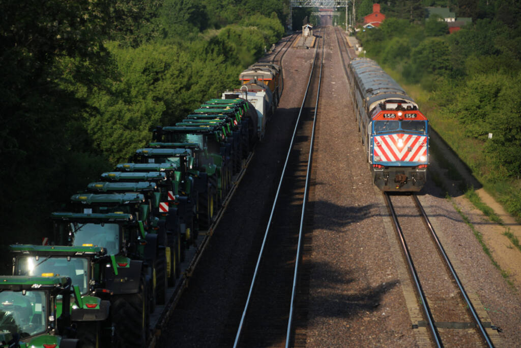 Commuter train and freight train meet, as seen in view from bridge