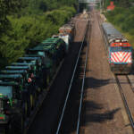 Commuter train and freight train meet, as seen in view from bridge