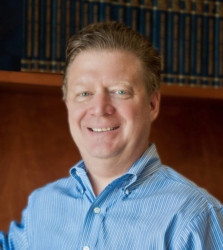 Head shot of smiling man in blue shirt
