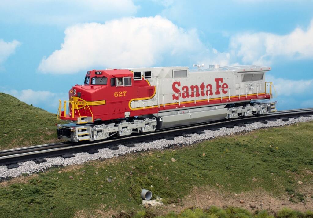 red and silver model locomotive on track