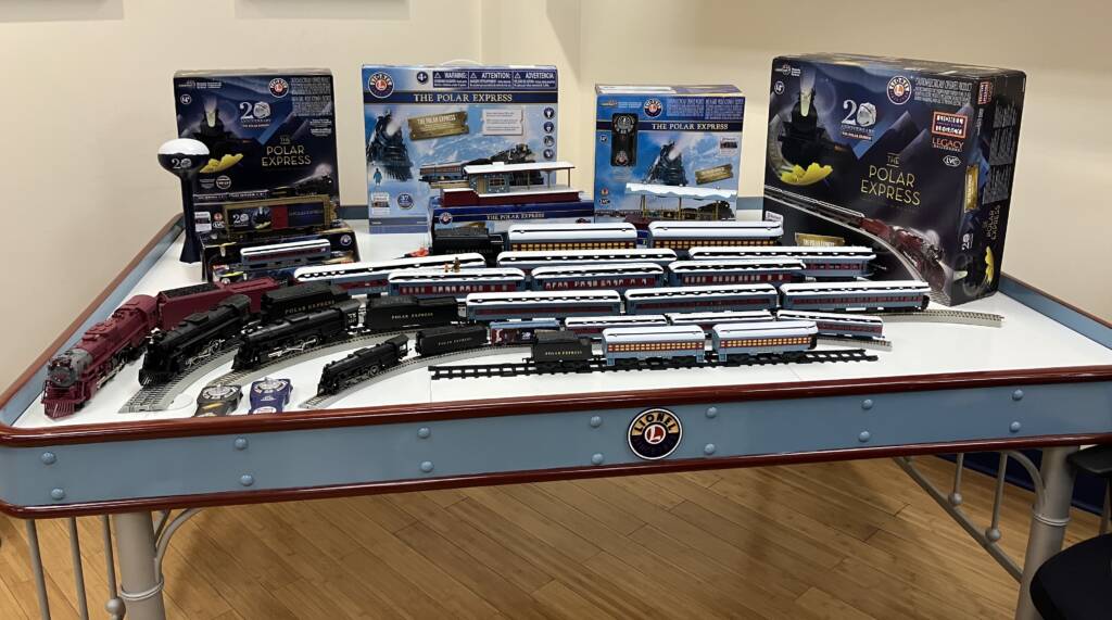 table with several train sets on it
