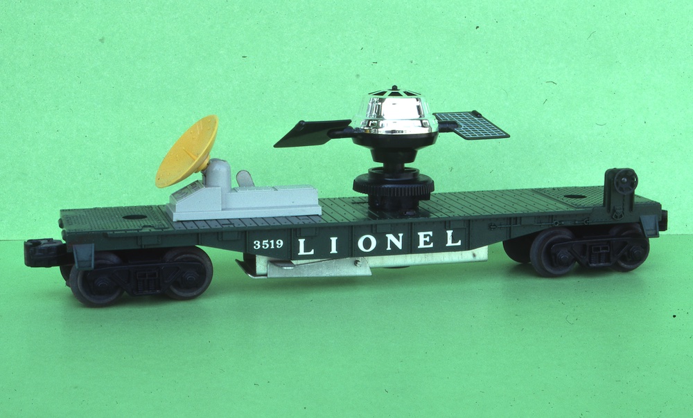 dark green, black, and silver flatcar with model satellite