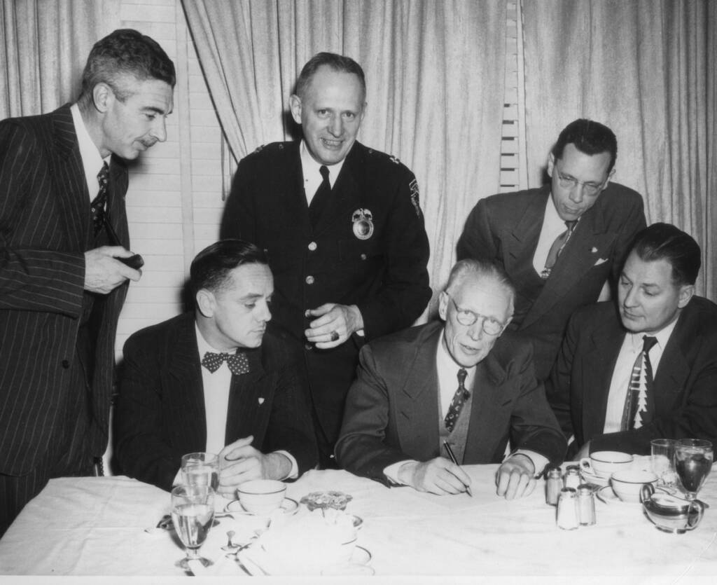 black and white photo of six men in suits