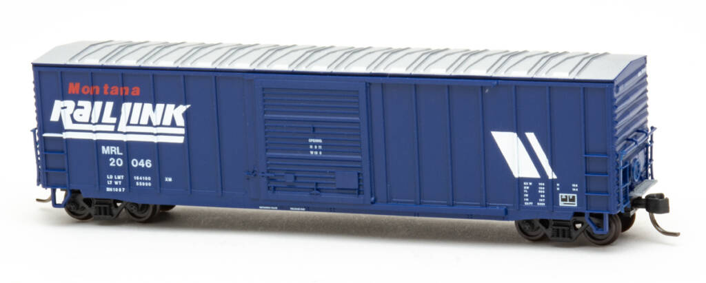 Color photo of N scale boxcar painted dark blue with aluminum roof and red and white graphics on white background