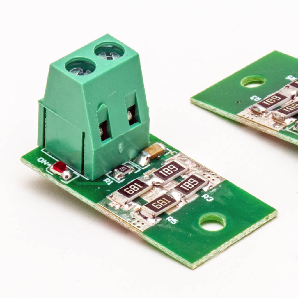 Color photo green printed-circuit boards with screw terminals on white background