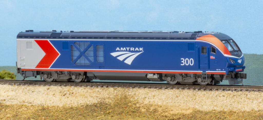  Color photo of modern N scale diesel in red, white, blue, and silver paint on scenicked base