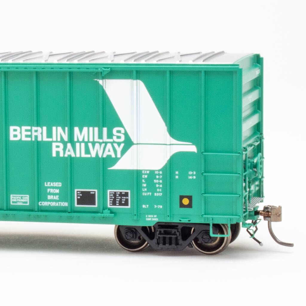 Color photo jade green boxcar with silver roof and white graphics on white background