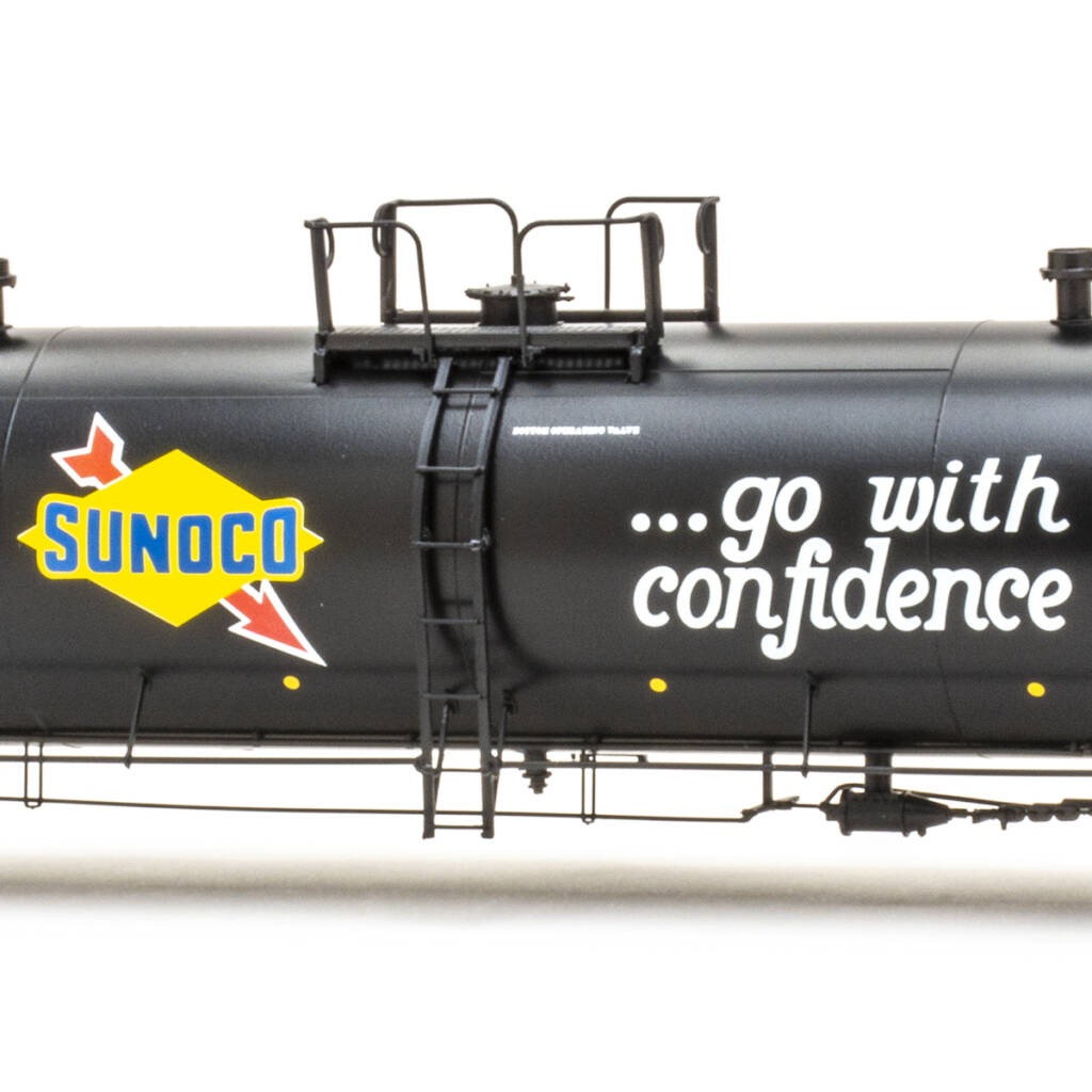 Color photo of HO scale tank car painted black with yellow, blue, red, and white graphics on white background