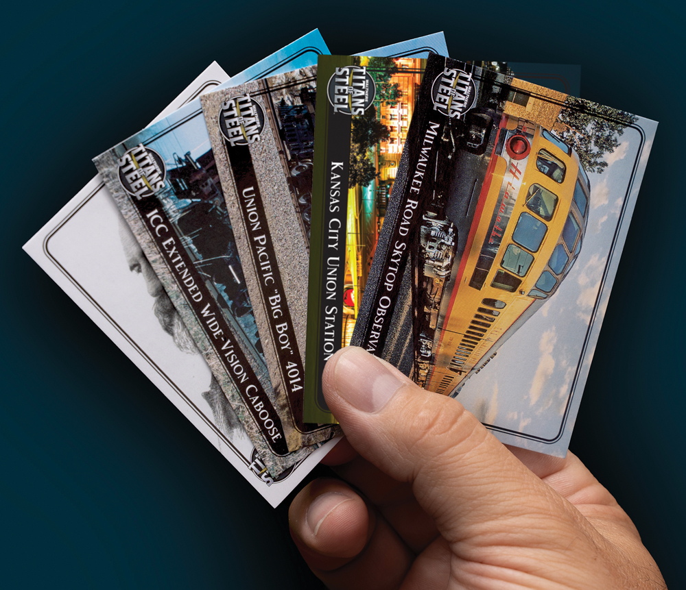 Color photo of hand holding five fanned-out trading cards against a dark background.