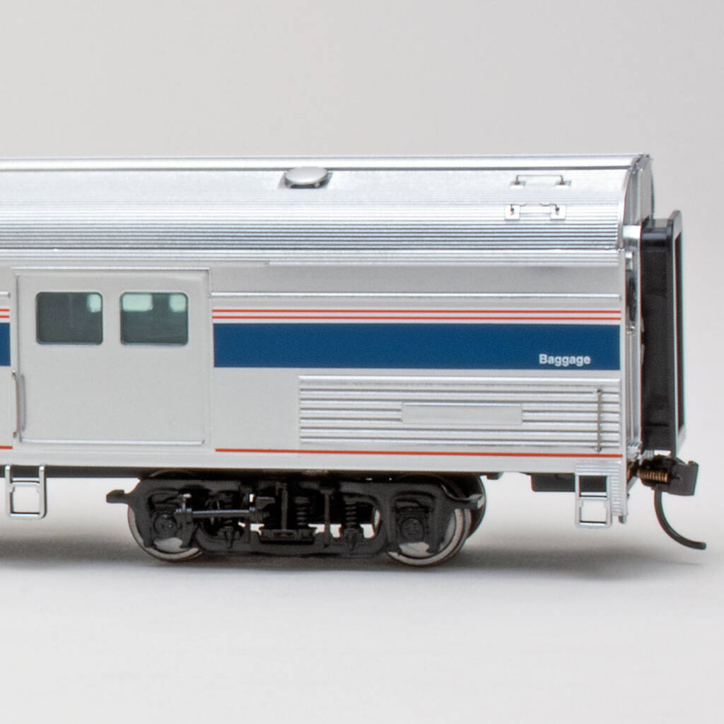 Color photo HO scale baggage car with metal finish and red, white, and blue graphics on white background