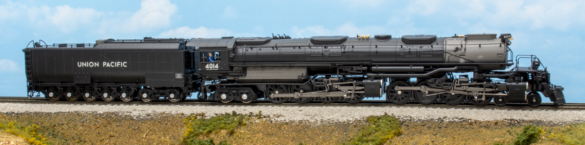 Color photo of HO scale steam locomotive painted black with silver graphics on scenicked base.