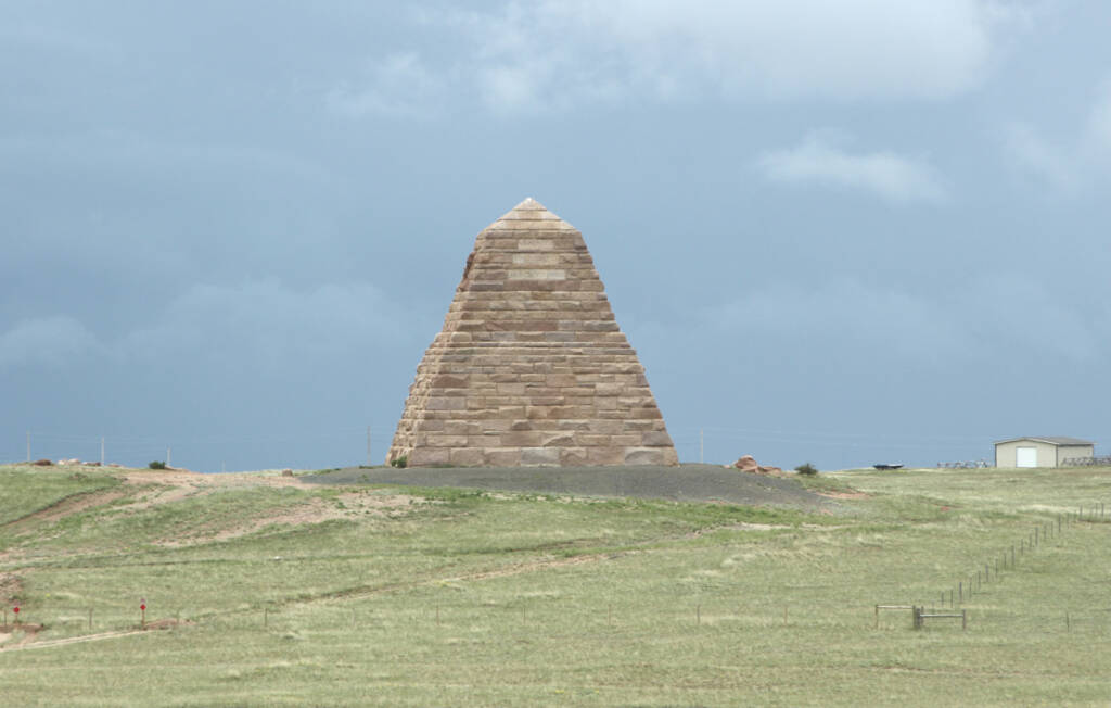 Stone pyramid-like building under threatening skies