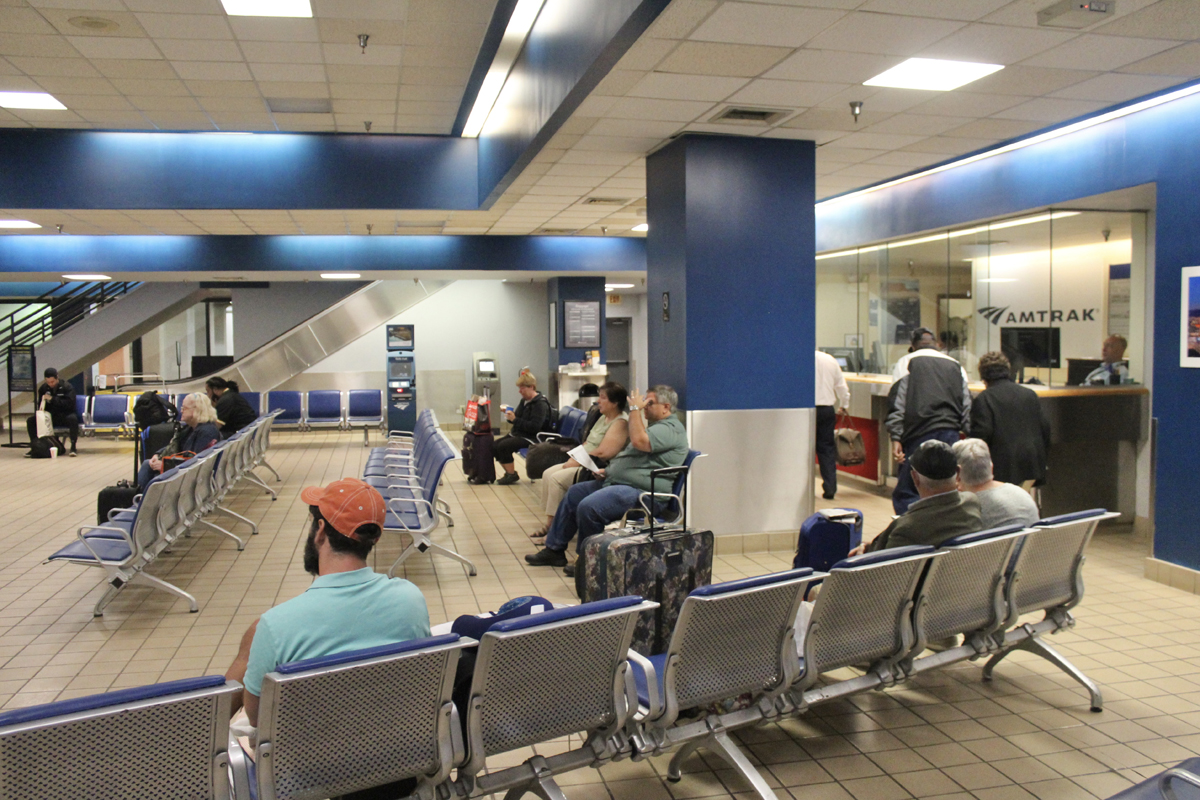 People sitting in railroad station waiting room