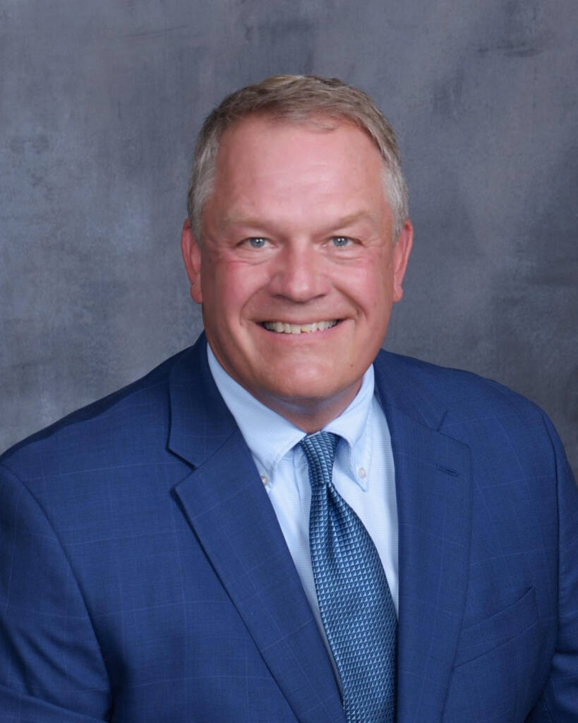 Smiling man in blue suit and tie