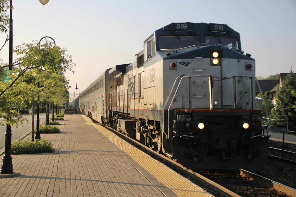 Passenger train led by road-switcher style locomotive