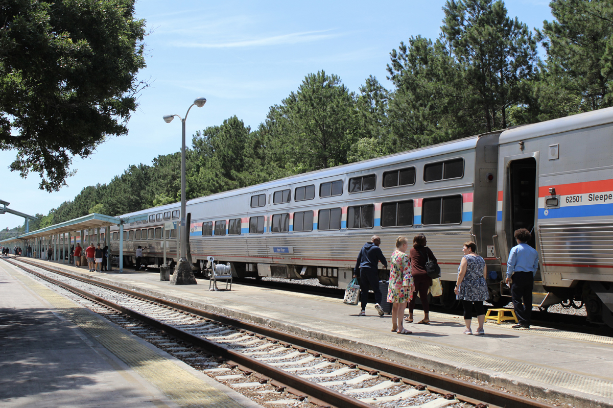 Passengers boarding single-level Amtrak equipment at station