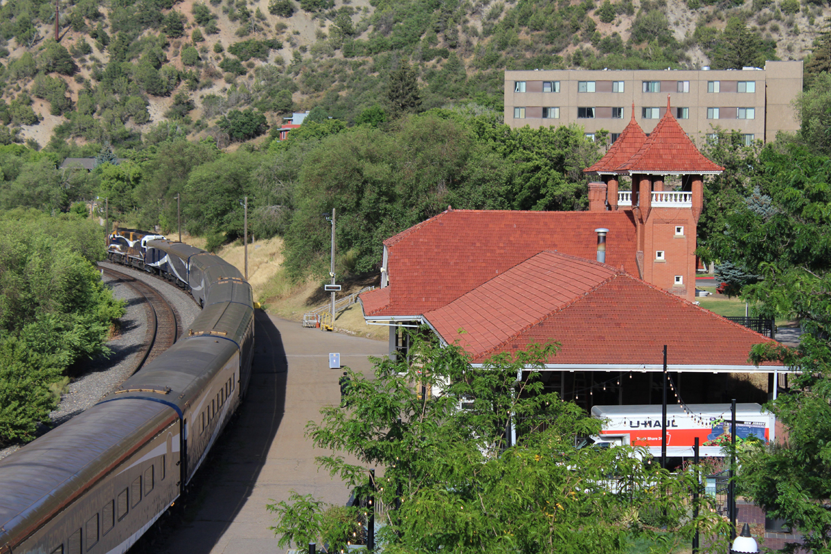 Train next to station with red roof