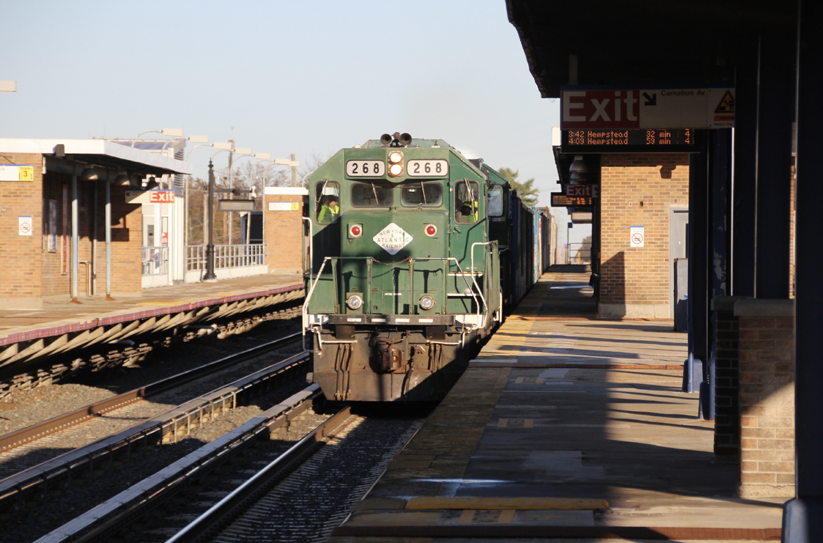 Green diesel locomotive at commuter train platform