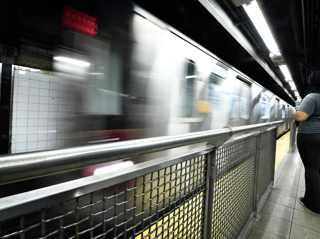 Fencing on edge of subway station platform