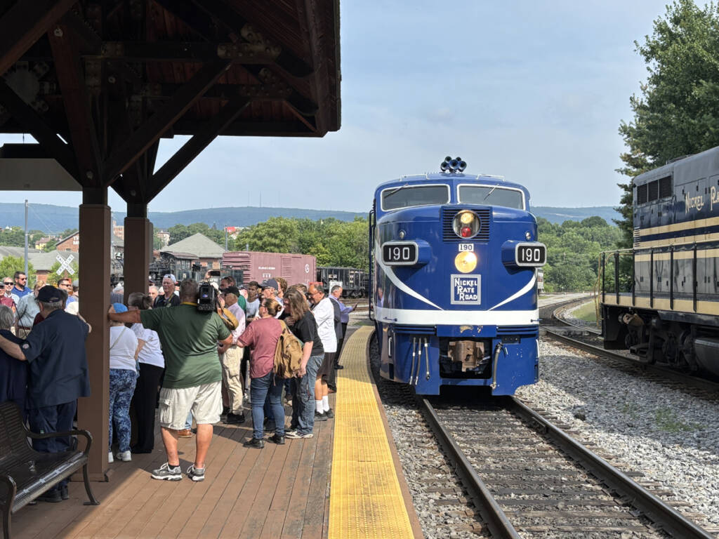 Blue and white diesel passenger loocomotive at station
