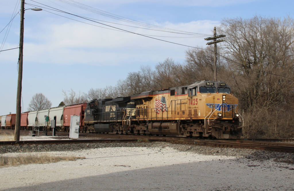 Freight train with one yellow locomotive and one black locomotive