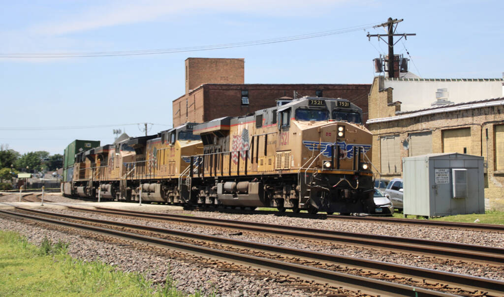 Train with three yellow locomotives on broad curve