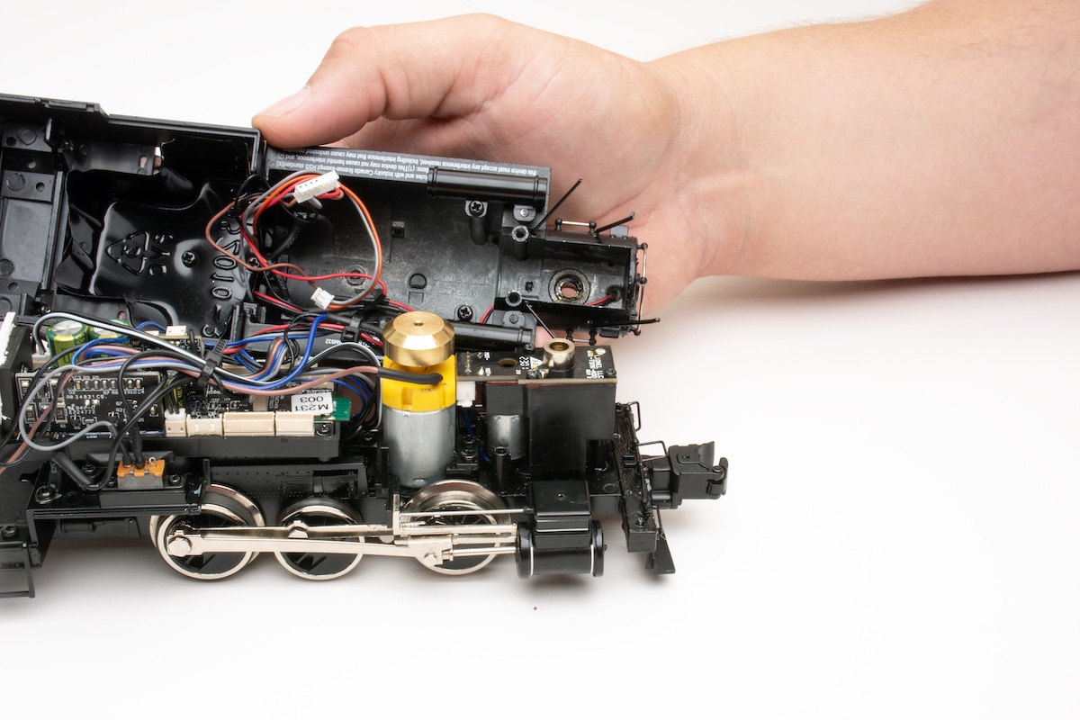 Model locomotive being put back together