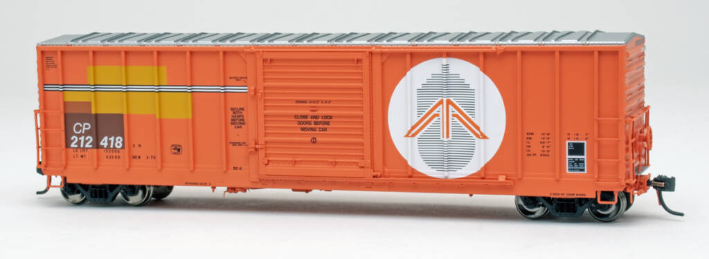 Color photo of HO scale boxcar painted orange with black, white, and orange graphics on white background