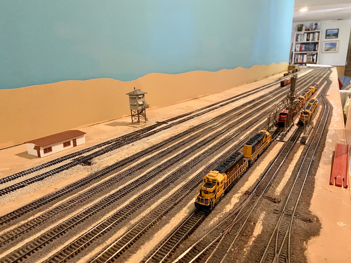 N scale yard with locomotives at a fueling station
