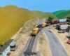 N scale freight trains rounds a curve at a railroad crossing