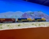 N scale train crosses a desert