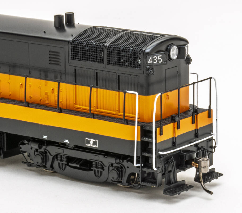 Photo showing rear of HO scale diesel painted orange and black on white background.